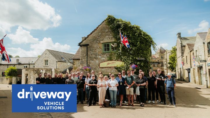 Driveway Vehicle Solutions Team Stood in Front of Old Building